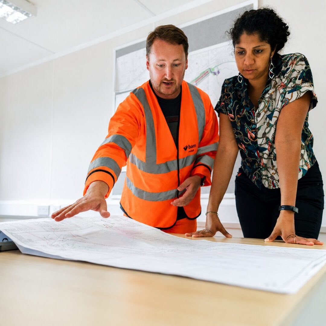 Team discussing architectural blueprints
