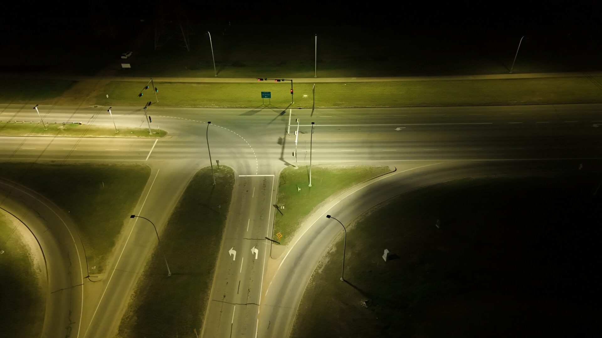 Aerial view of illuminated night intersection.