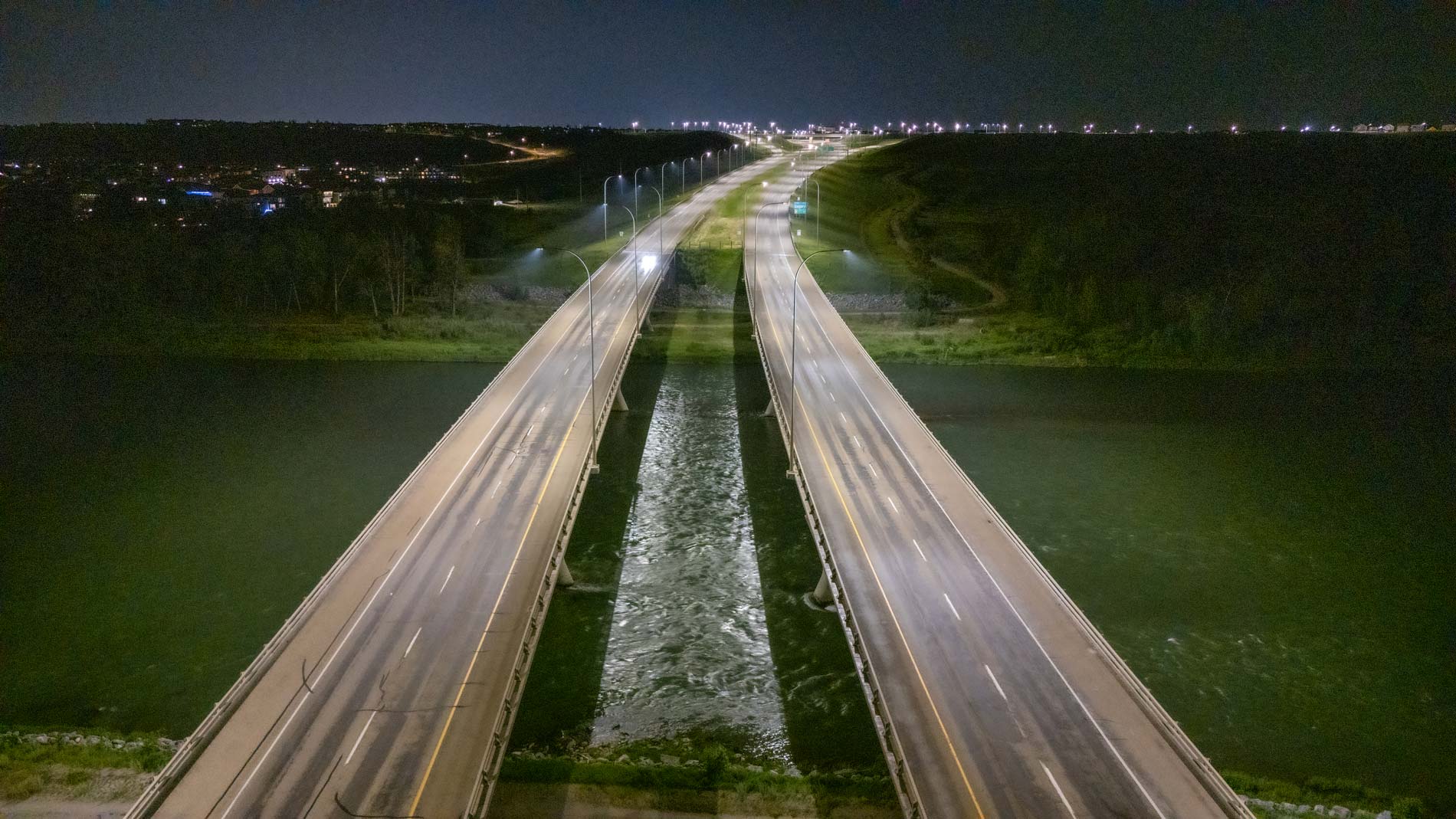 Aerial view of highway bridge at night.