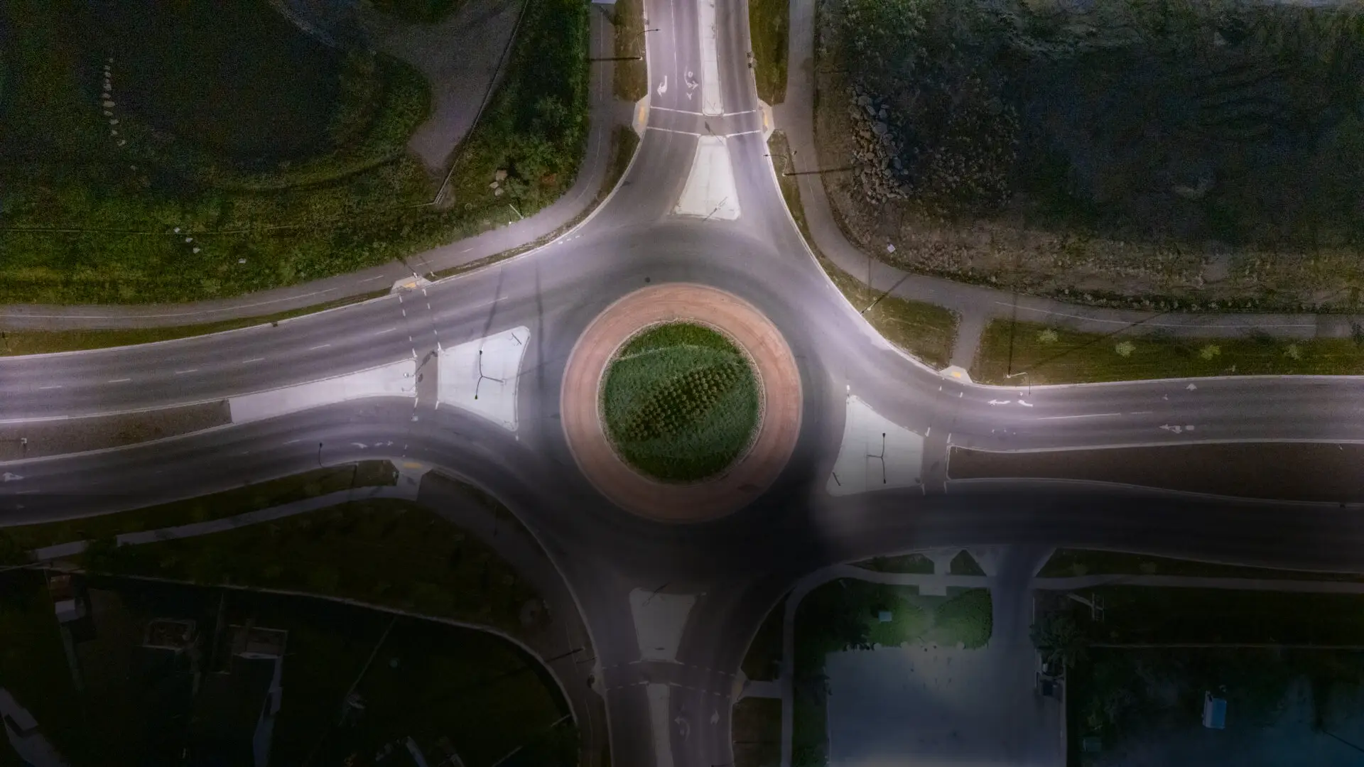 Aerial night view of landscaped traffic roundabout